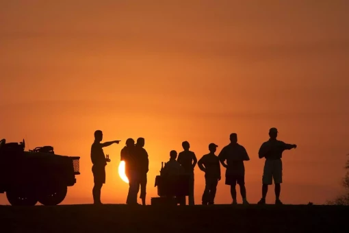 A picture of a group af tourists looking into the sunset